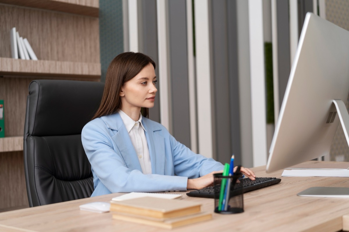Professional reviewing cost plans at her desk